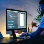 young man mobile developer writes program code on 3fbnk5r